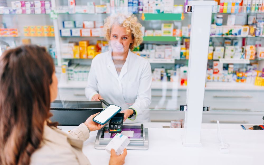 woman paying at pharmacy